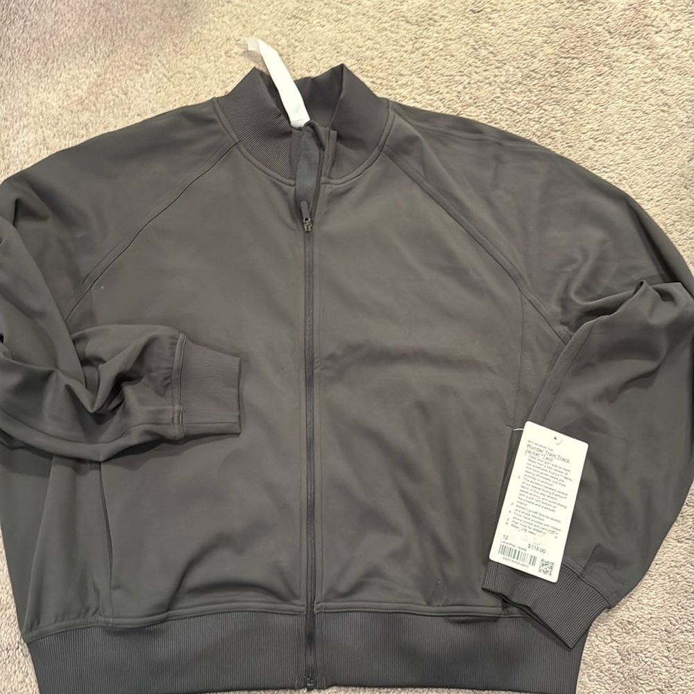 Brand New Women’s Lululemon Wunder Train Track Jacket Size 12 & Color dark Grey